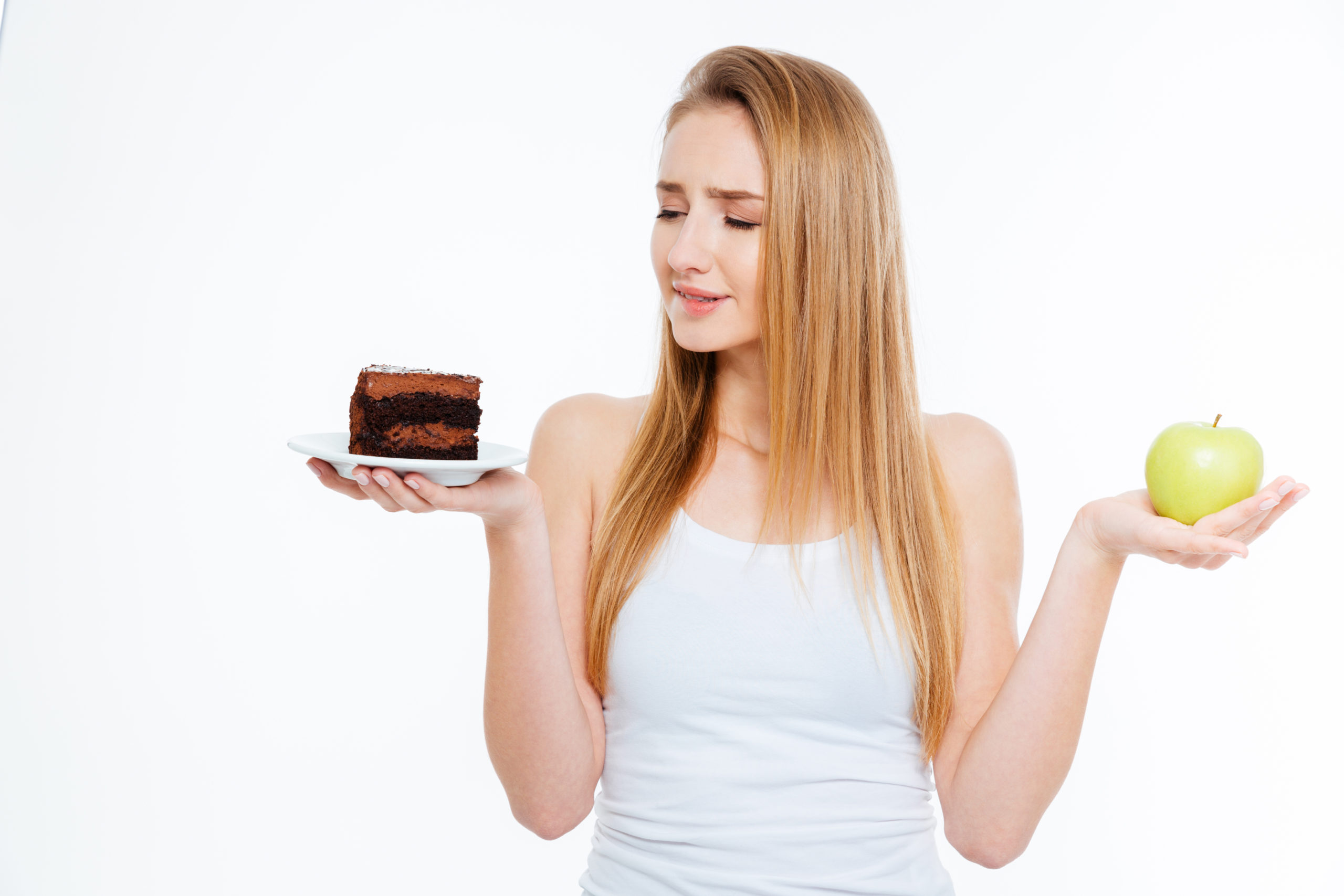 Confused woman choosing between healthy and unhealthy food