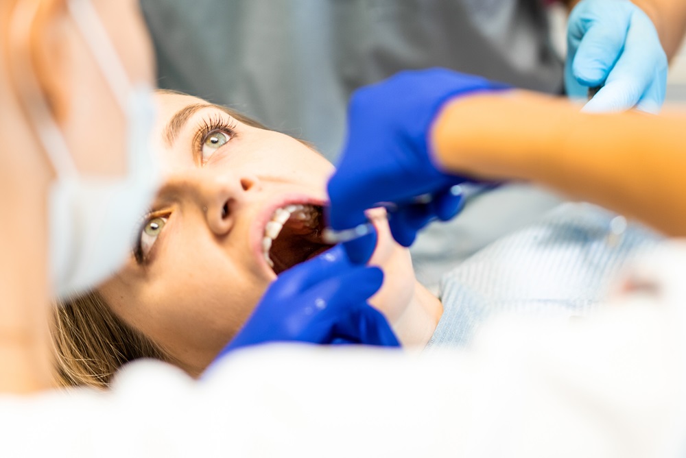 dentist performing tooth extraction treatment